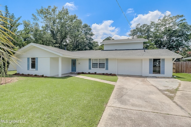 view of front of home featuring a garage and a front lawn