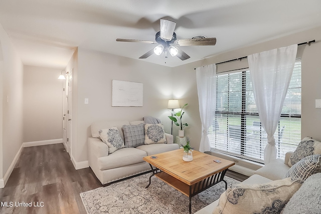 living room featuring dark hardwood / wood-style floors and ceiling fan