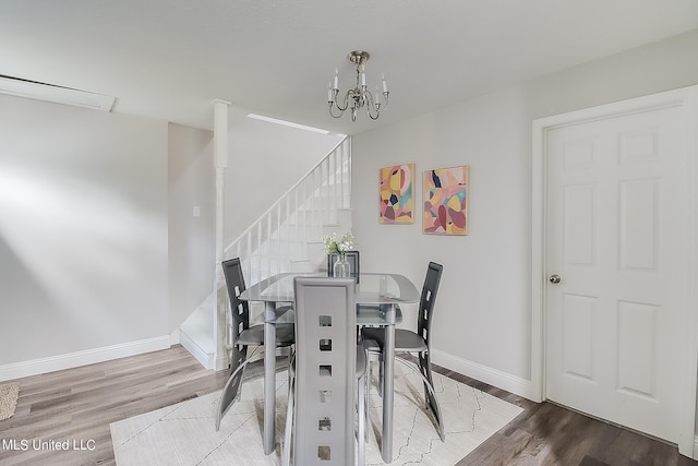 dining area featuring an inviting chandelier and wood-type flooring