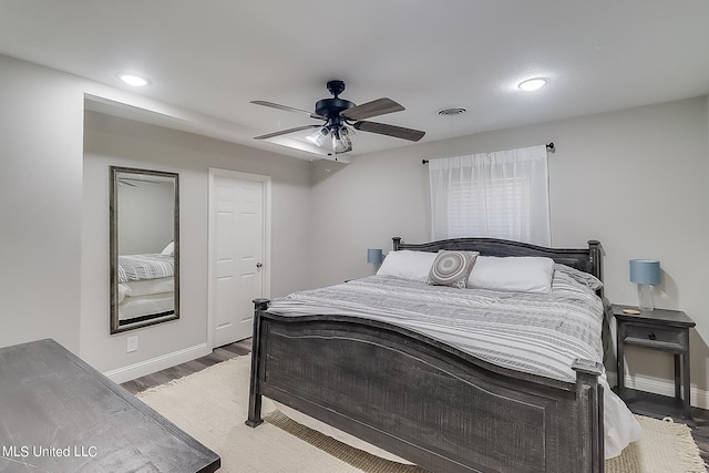 bedroom with ceiling fan and dark hardwood / wood-style floors