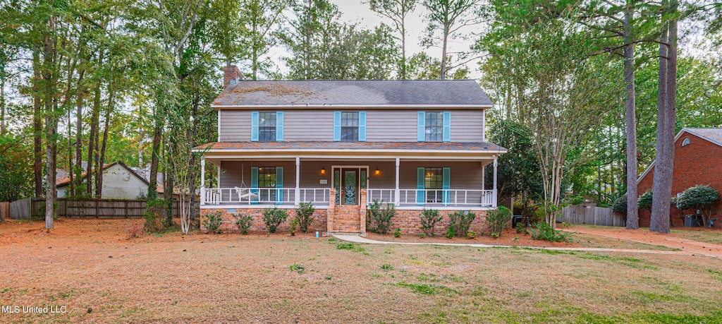 545 Dixton Dr, Brandon, MS 39047 - view of front facade featuring fence, a chimney, and a porch