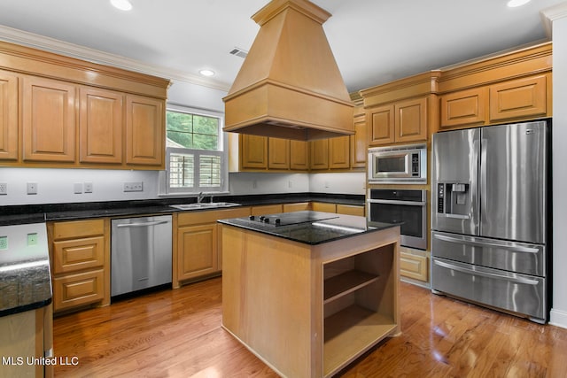 kitchen with custom range hood, crown molding, a center island, light wood-type flooring, and appliances with stainless steel finishes