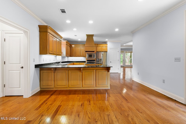 kitchen featuring kitchen peninsula, stainless steel appliances, ornamental molding, sink, and light hardwood / wood-style floors