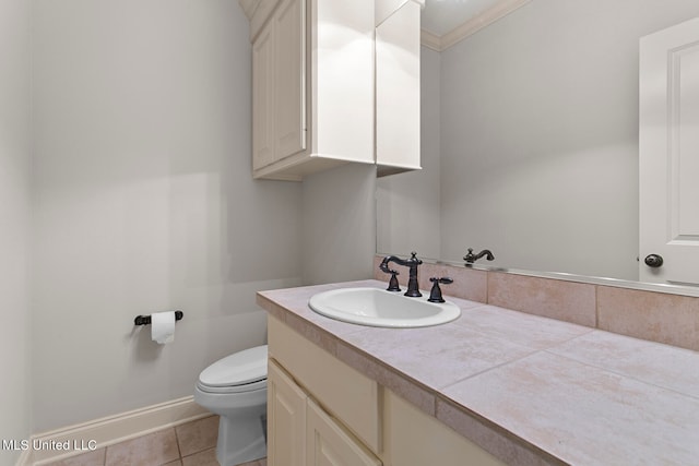 bathroom featuring toilet, ornamental molding, vanity, and tile patterned flooring