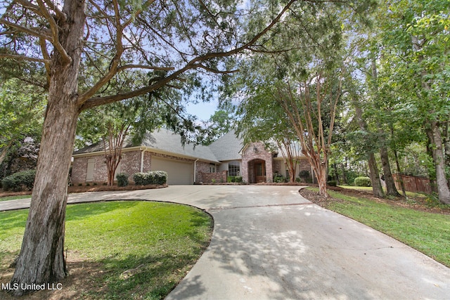 view of front of home with a front yard and a garage