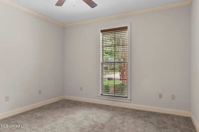 empty room with ornamental molding, carpet flooring, and ceiling fan