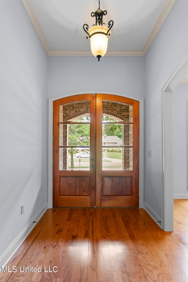 doorway featuring french doors, crown molding, and hardwood / wood-style floors