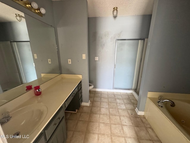 9193 S Kaitlyn Dr, Walls, MS 38680 - full bathroom with vanity, a garden tub, baseboards, a textured ceiling, and a shower stall