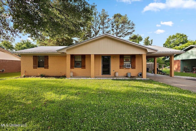 791 Leach St, Yazoo City, MS 39194 - single story home with asphalt driveway, brick siding, a carport, a front lawn, and cooling unit