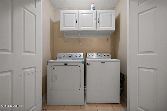 791 Leach St, Yazoo City, MS 39194 - washroom with independent washer and dryer, cabinet space, and light tile patterned floors