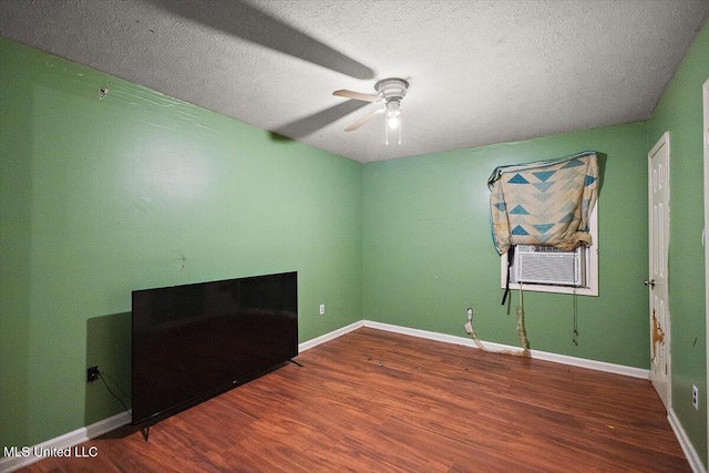 791 Leach St, Yazoo City, MS 39194 - unfurnished room featuring a ceiling fan, cooling unit, wood finished floors, a textured ceiling, and baseboards
