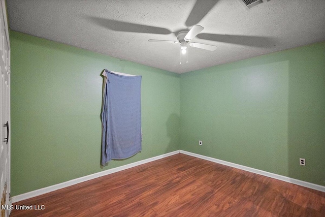 791 Leach St, Yazoo City, MS 39194 - spare room featuring wood finished floors, a ceiling fan, baseboards, and a textured ceiling