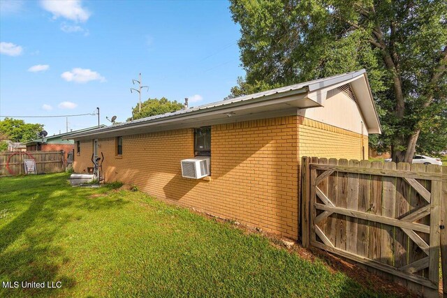 791 Leach St, Yazoo City, MS 39194 - view of property exterior with brick siding, metal roof, and cooling unit