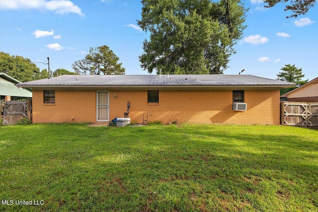 791 Leach St, Yazoo City, MS 39194 - back of house featuring brick siding, metal roof, and cooling unit