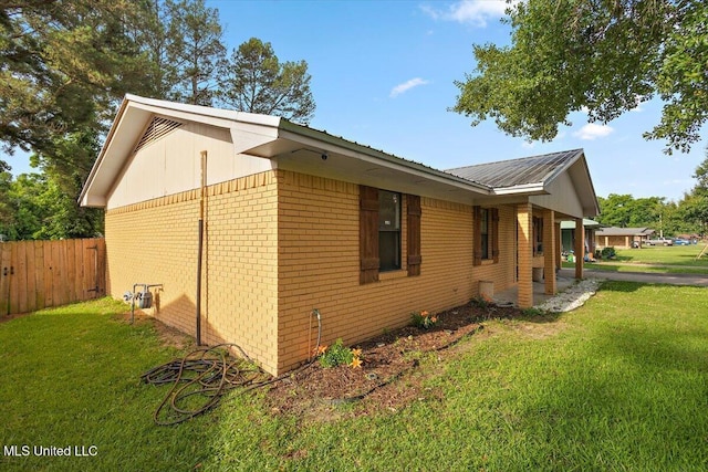 791 Leach St, Yazoo City, MS 39194 - view of side of property featuring brick siding and metal roof