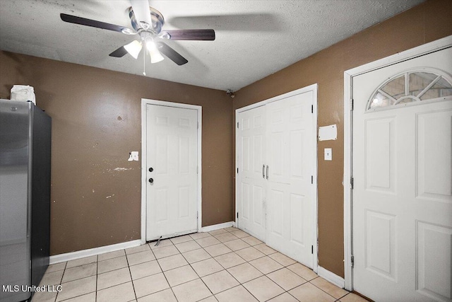 791 Leach St, Yazoo City, MS 39194 - foyer with a ceiling fan, baseboards, light tile patterned flooring, and a textured ceiling
