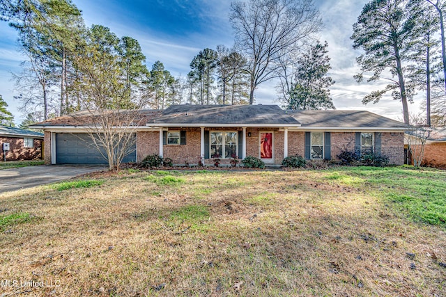 ranch-style house with brick siding, an attached garage, driveway, and a front lawn