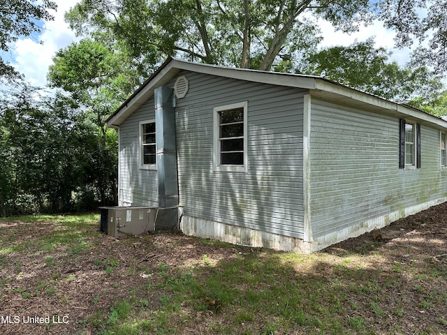 view of side of home with central air condition unit