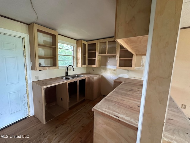 kitchen with light brown cabinetry, sink, and light wood-type flooring