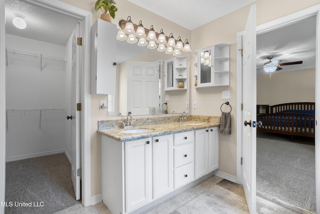 bathroom featuring vanity, a textured ceiling, and ceiling fan