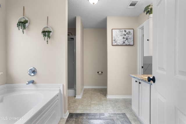 bathroom with tile patterned flooring, a textured ceiling, independent shower and bath, and vanity