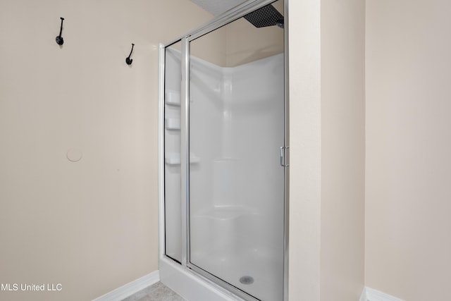 bathroom featuring a shower with door and tile patterned floors