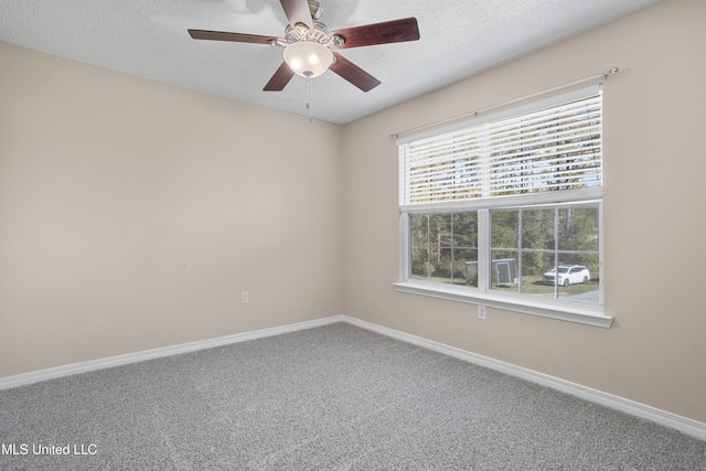 unfurnished room with a textured ceiling, ceiling fan, and carpet flooring