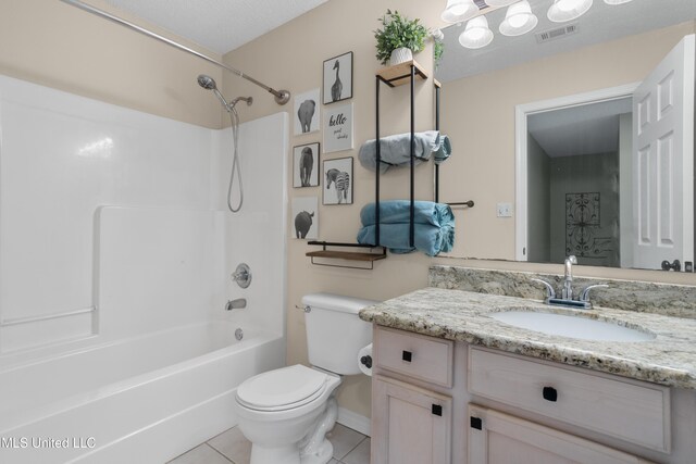 full bathroom featuring vanity, tile patterned flooring, toilet, and tub / shower combination