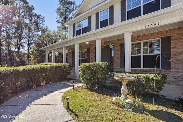 view of exterior entry with covered porch