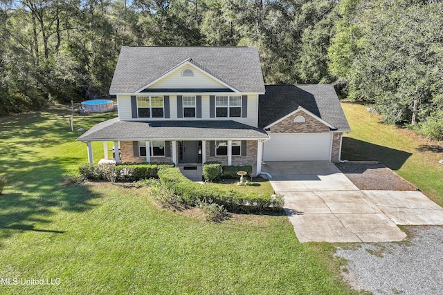 view of front facade with a porch, a front lawn, and a garage