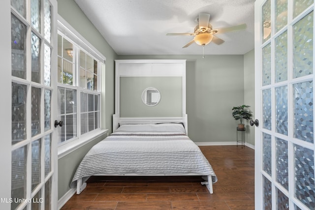 bedroom with a textured ceiling and ceiling fan