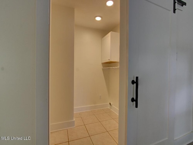 spacious closet with light tile patterned floors