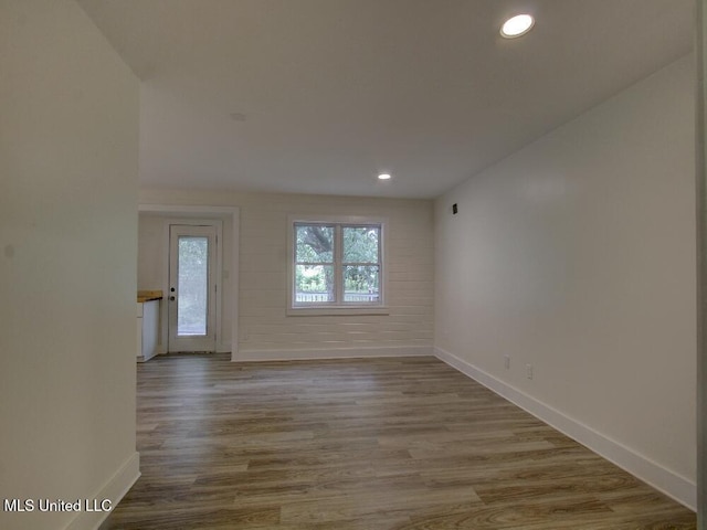 unfurnished room with baseboards, recessed lighting, and wood finished floors