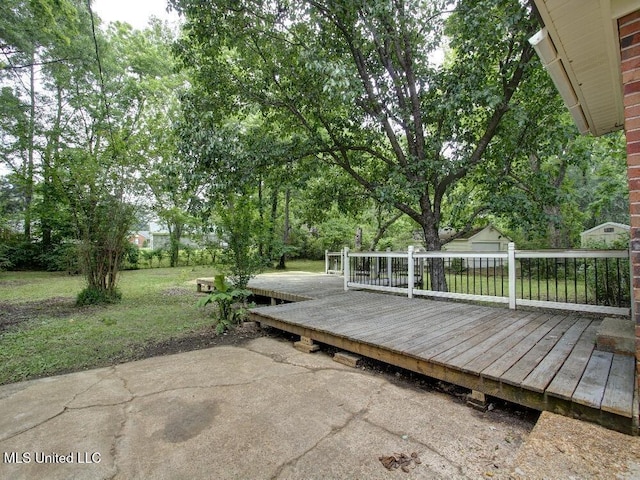 view of patio with a deck and view of scattered trees