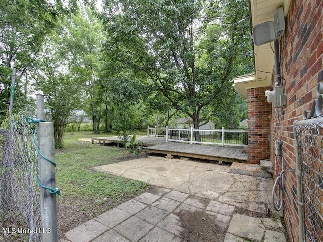view of yard with a wooden deck and a patio area