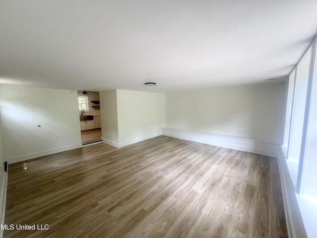 unfurnished room with wood finished floors and baseboards