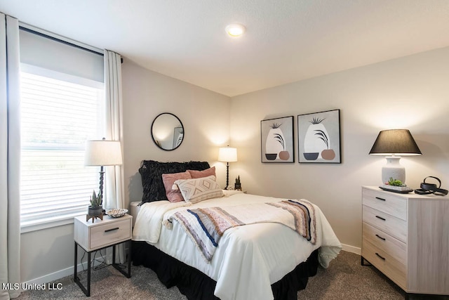 bedroom featuring dark carpet