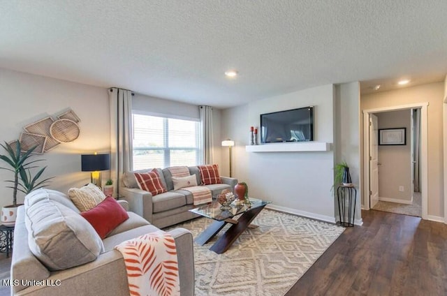 living room featuring a textured ceiling and hardwood / wood-style flooring