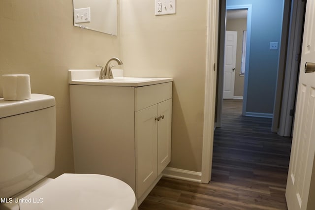 bathroom with vanity, hardwood / wood-style flooring, and toilet