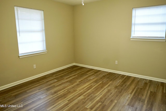 spare room with hardwood / wood-style floors