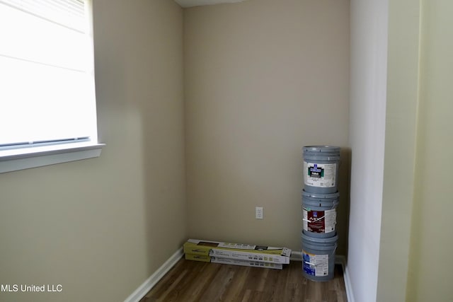 laundry area featuring dark wood-type flooring