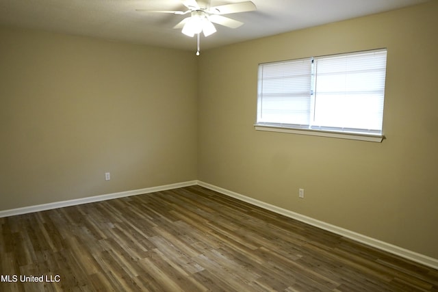 empty room featuring dark wood-type flooring and ceiling fan