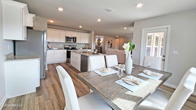 dining space featuring visible vents, recessed lighting, and dark wood-type flooring
