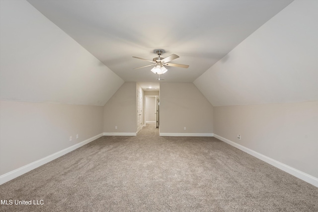 additional living space featuring ceiling fan, carpet floors, and vaulted ceiling