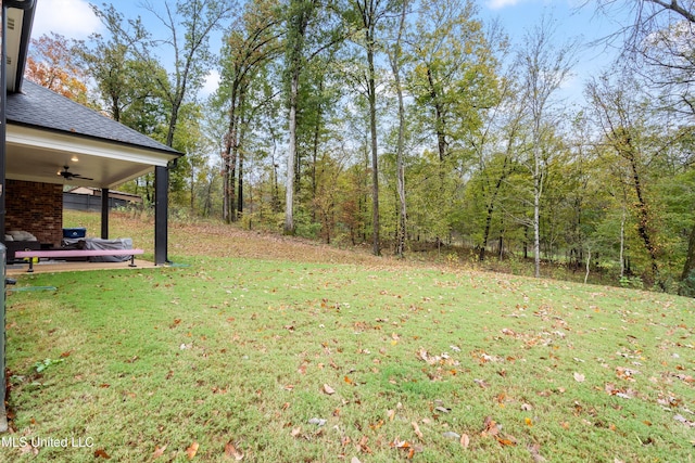 view of yard with ceiling fan