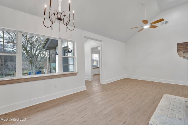 unfurnished living room with visible vents, baseboards, high vaulted ceiling, and wood finished floors