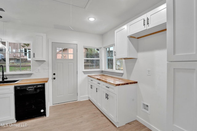 kitchen with white cabinetry, a sink, light wood-style floors, wood counters, and dishwasher