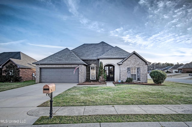 french country inspired facade with a front lawn and a garage