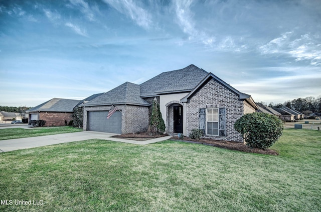 french country home with a front lawn and a garage