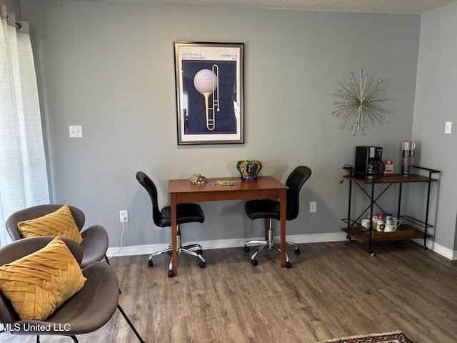 office space with baseboards and wood finished floors